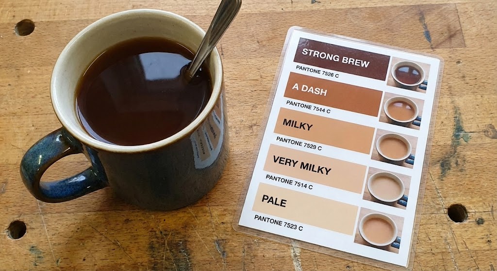 strong British builders tea in mug showing Pantone color chart milkiness levels