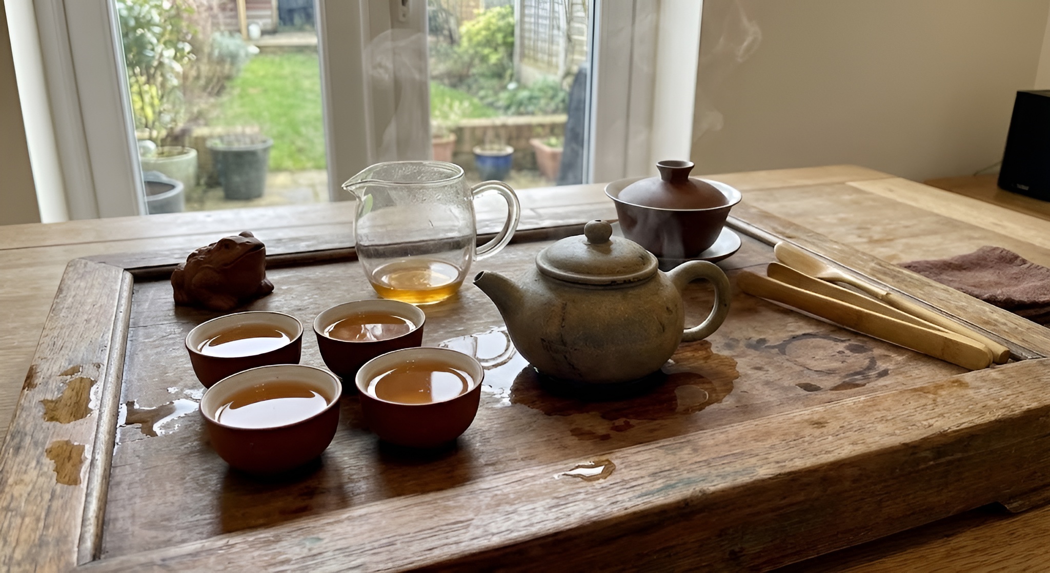 A traditional gongfu tea setup with a clay teapot and small cups.