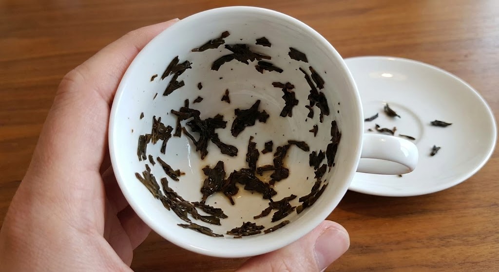 tea cup inverted with tea leaves forming patterns tasseography fortune telling